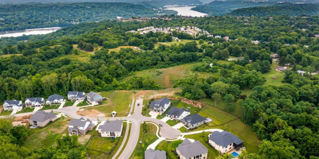 Aerial view of Rivers Pointe Estates in Hebron, KY, with Justin Doyle Homes custom home lots and scenic Ohio River in the background, showcasing privacy and spacious lots.
