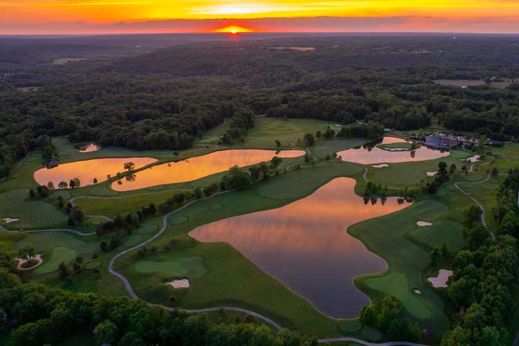 Sunset view of the golf course and ponds at Stonelick Hills in Batavia, OH, with Justin Doyle Homes custom home lots nearby, highlighting scenic and private surroundings.