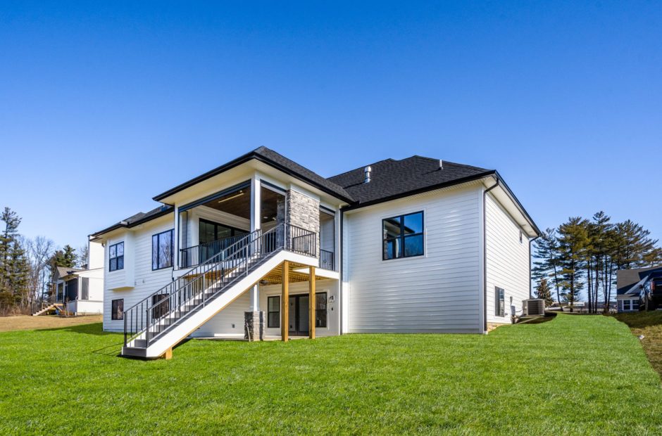 Heatherwood floor plan backyard with enclosed patio and outdoor fireplace by Justin Doyle Homes